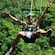 A guy in zip line from the tree tops